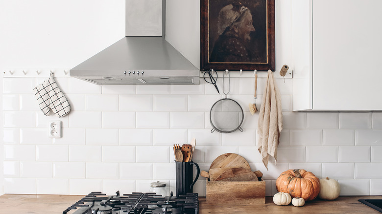 Modern eclectic kitchen interior with oil painting and wooden countertop