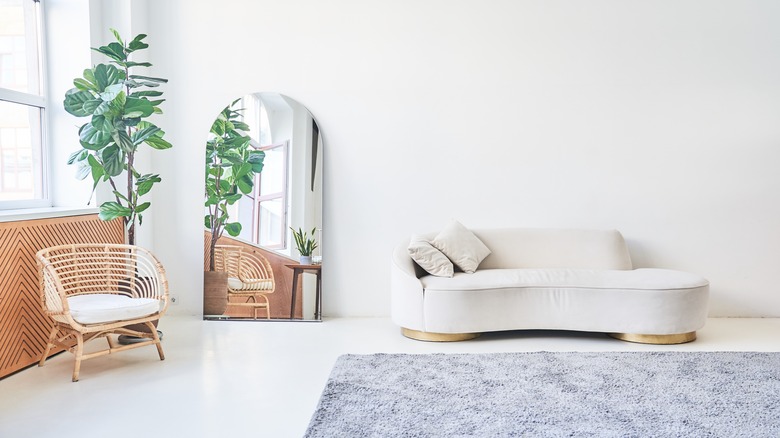 Modern, white minimalist living room with a white sofa