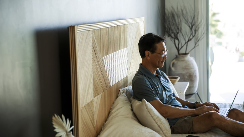 man sitting on bed