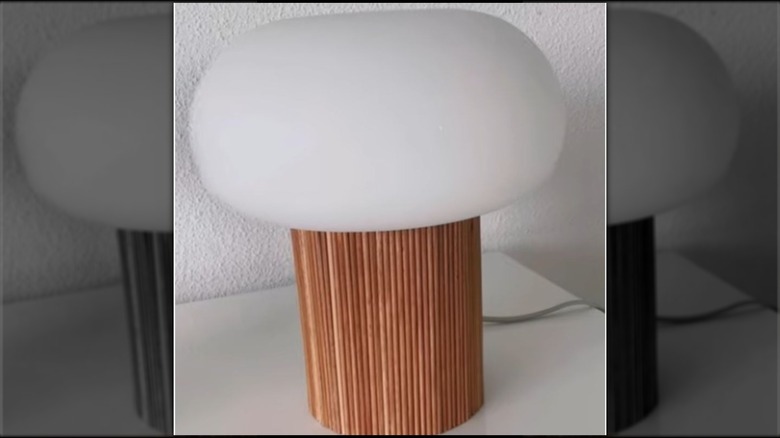 A small mushroom lamp with a wooden dowel base