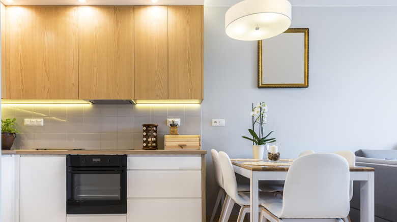 Kitchen with spotlight lamps shone on cabinetry