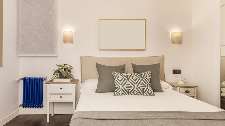 Wall sconces in bedroom above the headboard