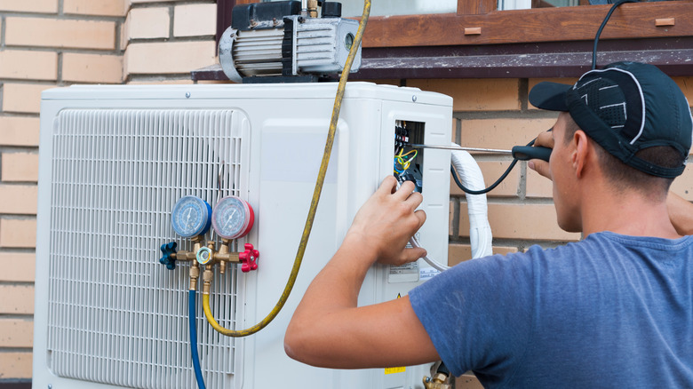 worker installing central AC