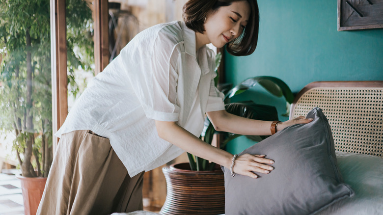 woman making bed