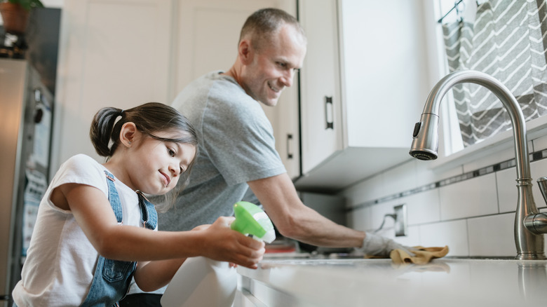 family cleaning kitchen