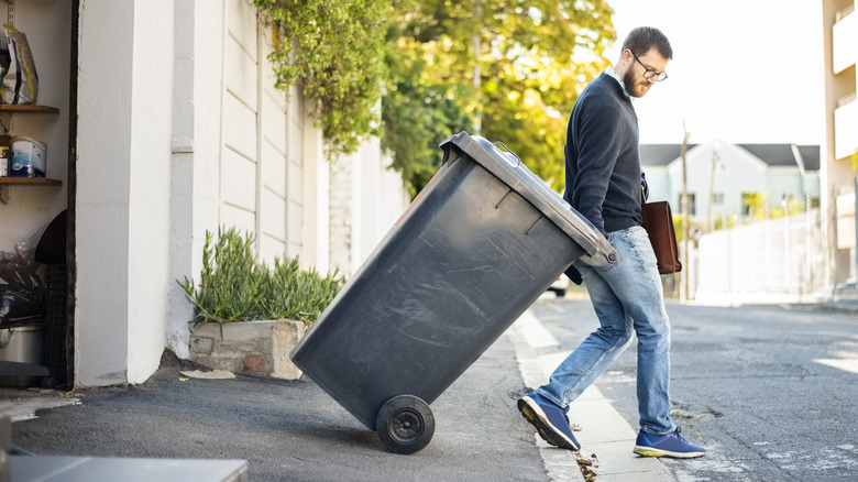 man taking out trash