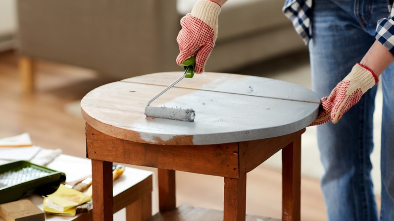 person painting a table