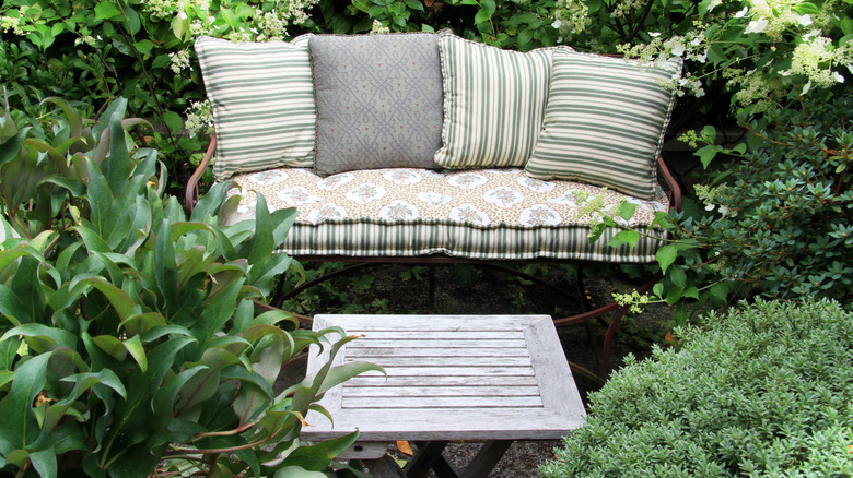 Fabric cushions on a garden bench.