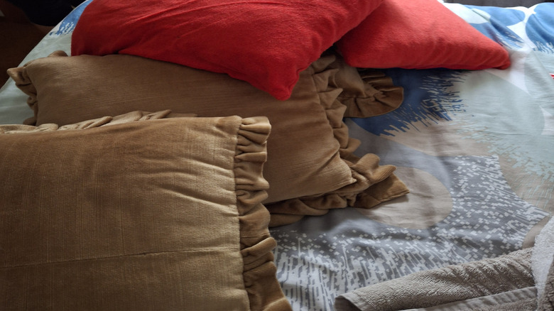 A pile of worn out throw pillows