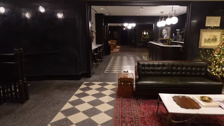 Black and white checkerboard tile, with dark walls and white ceiling in Hotel 1928