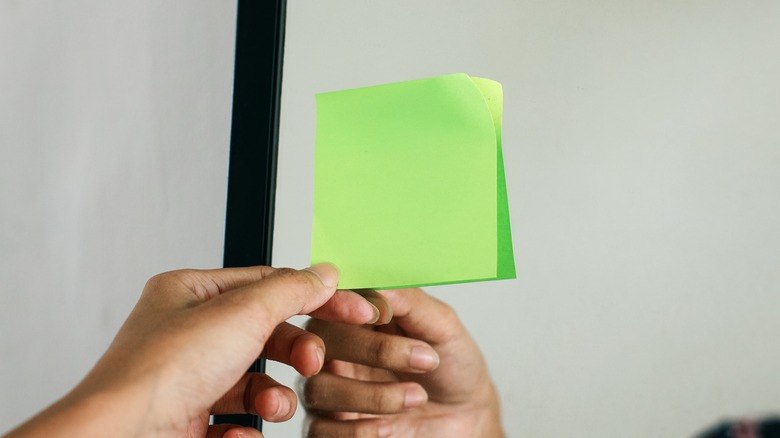 green sticky note on mirror