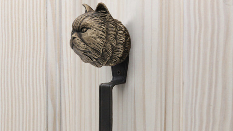 A door pull styled after a Persian cat.