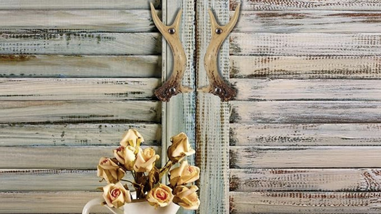 Antler-shaped door handles on a cabinet door.