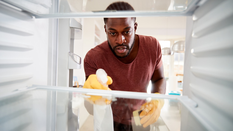 Man cleaning fridge