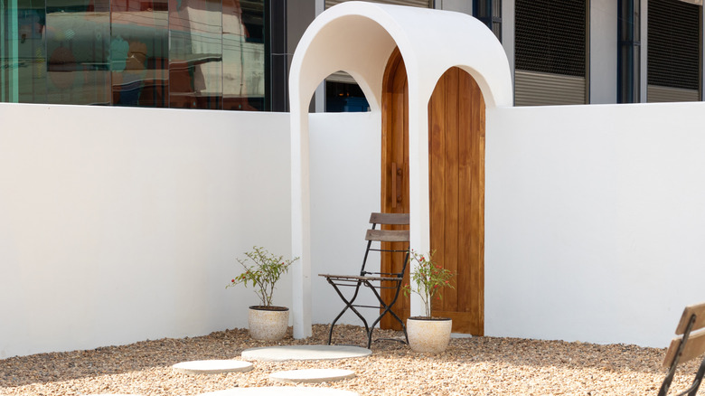 White arched doorway in backyard