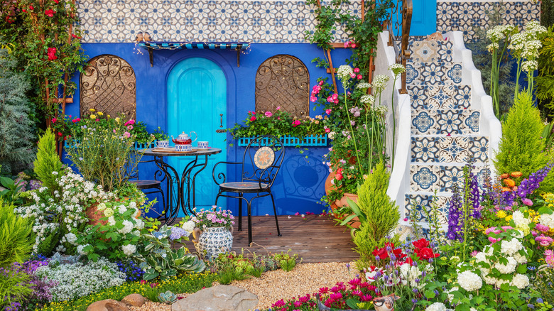 Mediterranean-inspired backyard with garden and mosaic tile walls