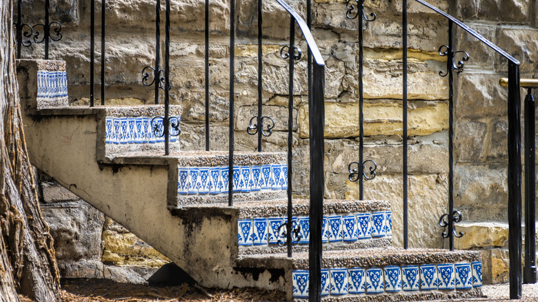 Outdoor concrete staircase with vibrant mosaic tiles