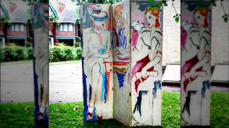 Colorful painting of women on wood divider