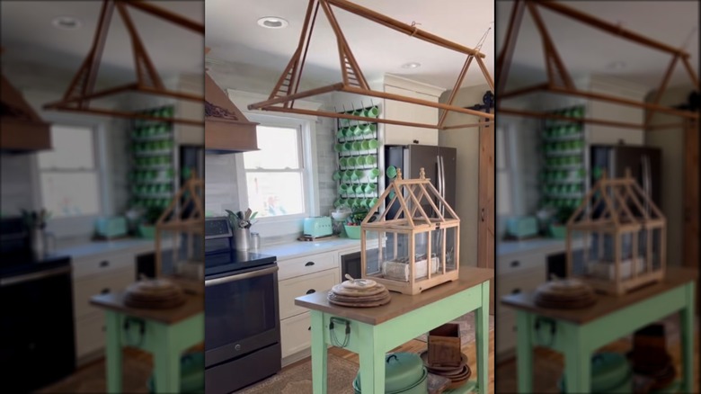 Wood hanging divider rack above island in kitchen