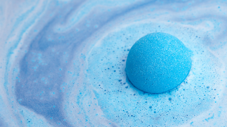 blue bath bomb fizzing water