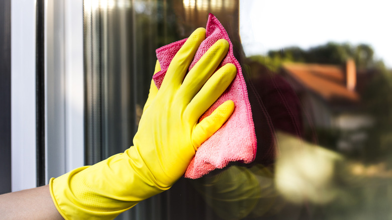 Person cleaning glass window