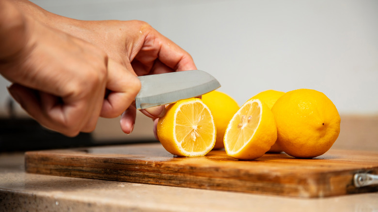 person slicing lemon