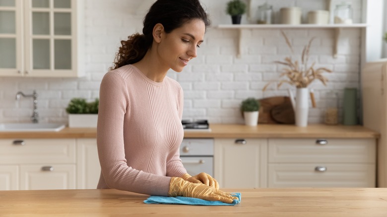 Woman cleaning the kitchen counter 