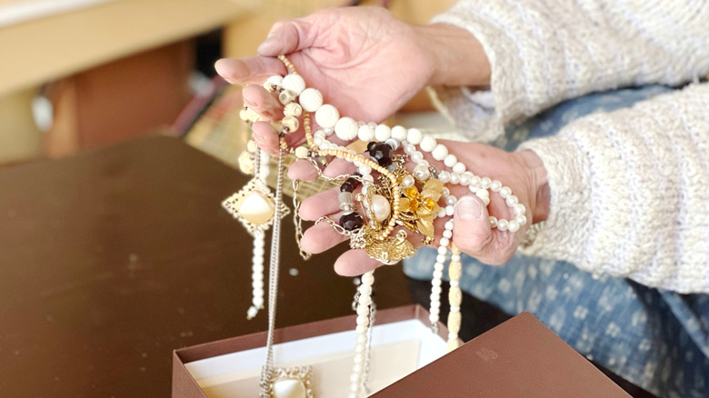 Person holding a mess of jewelry