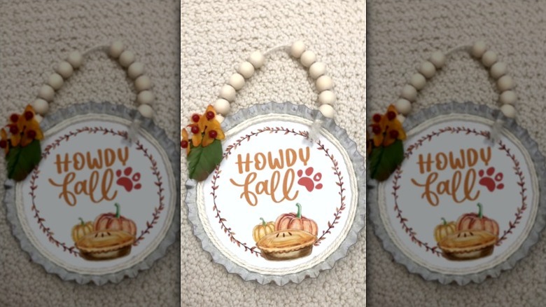 Handcrafted pie tin holiday season ornament with "Howdy Fall" written on it.