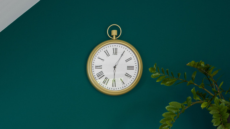 clock on a green wall