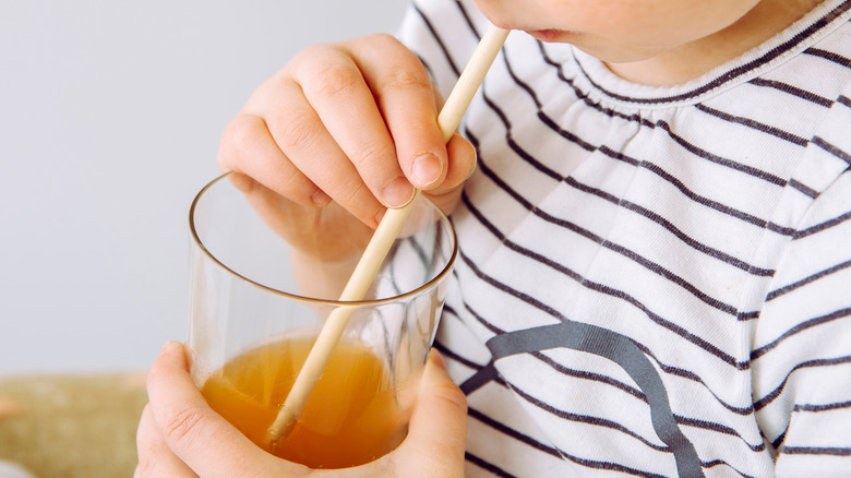 Child drinking from reusable bamboo straw