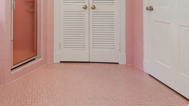 Pink tiles on bathroom floor and up walls