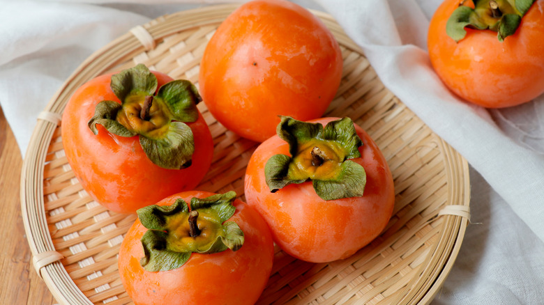 fresh persimmons on tray