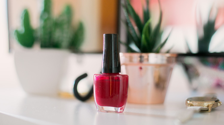 bottle of red nail polish and countertop