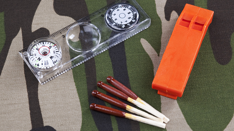 Waterproof painted matches on a table with other gear