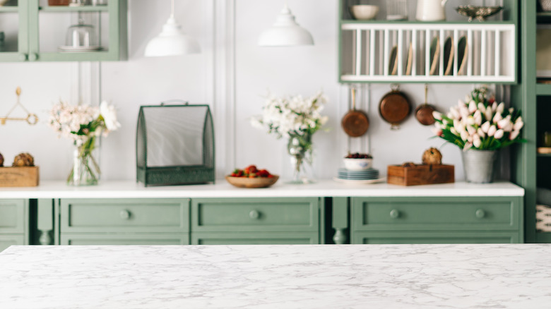 green cabinets and white countertops