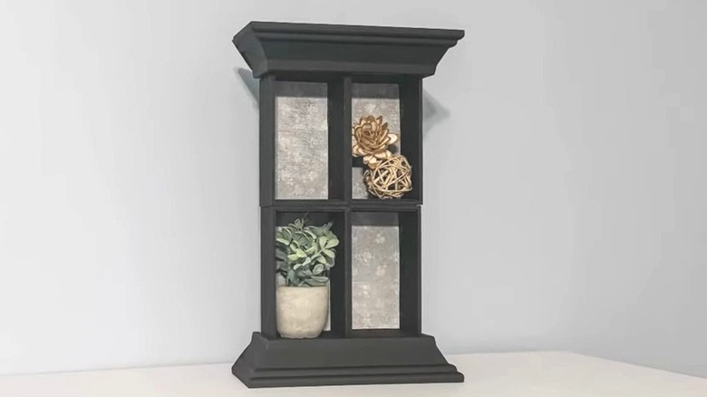 Standing DIY shadow box with grey interior backgrounds holds planter and vase fillers as decor