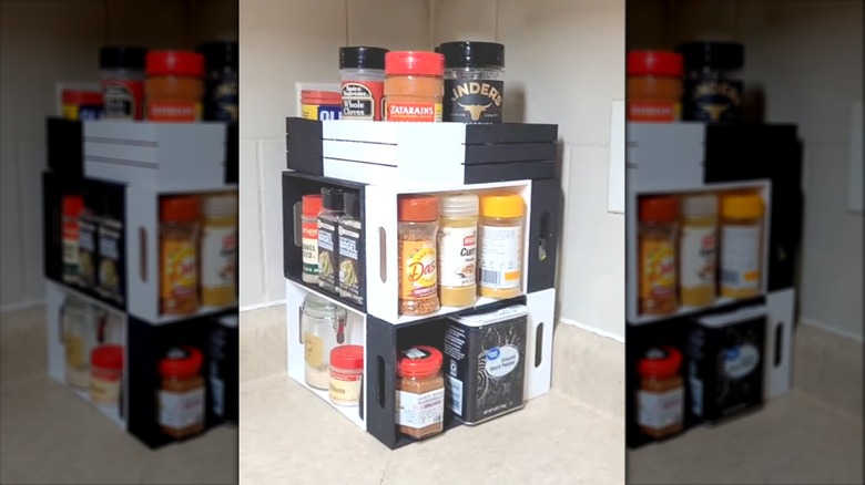 Collection of spices arranged on a DIY wooden spice tower on a kitchen countertop