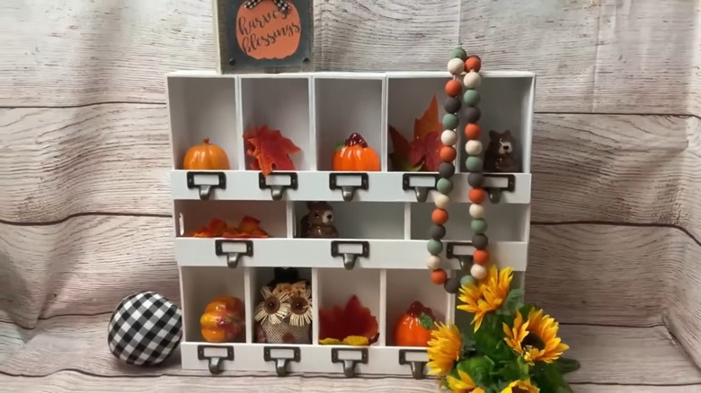 White crate shelves with decorative brackets decorated for fall