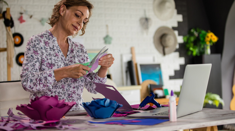 woman cutting paper flowers