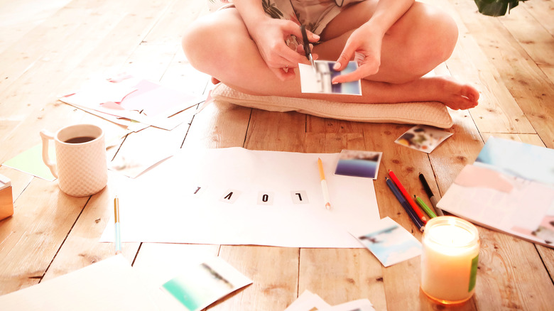 woman cutting pictures for art