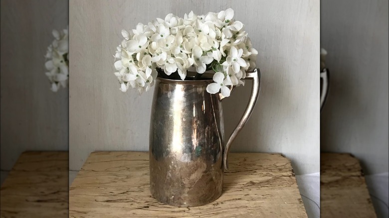 silver pitcher with white flowers