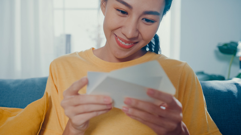 woman opening envelope