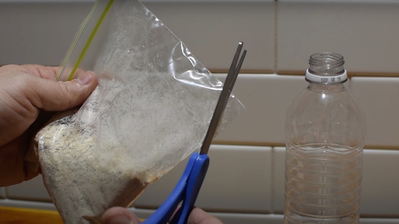 person cutting bag into funnel