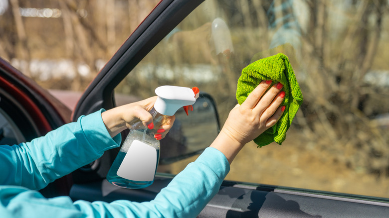 someone cleaning car windows