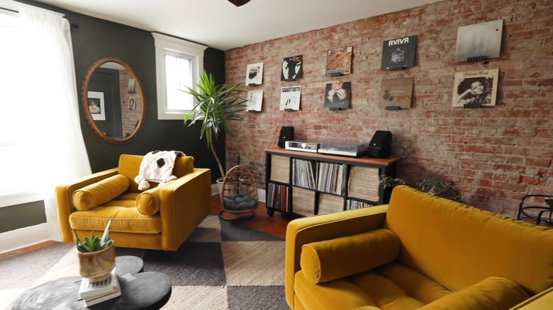 Room with black and brick walls