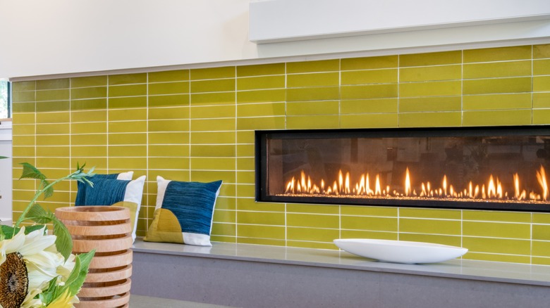 chartreuse fireplace with blue pillows