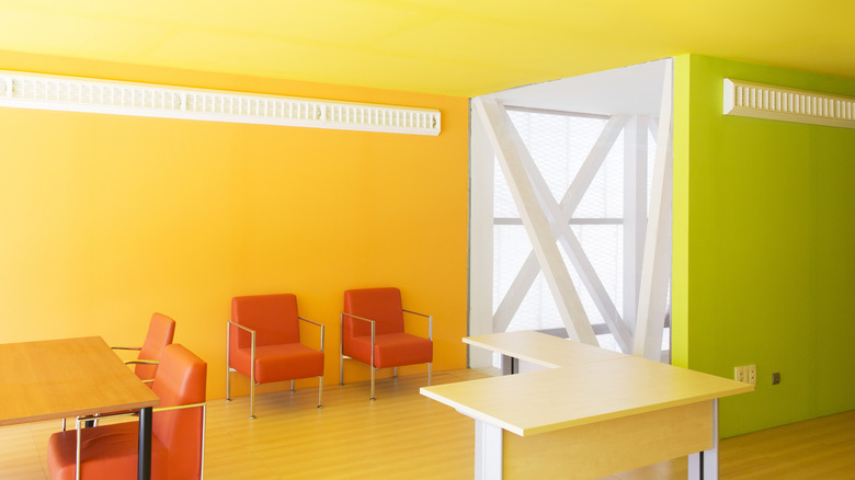 chartreuse wall and orange chairs