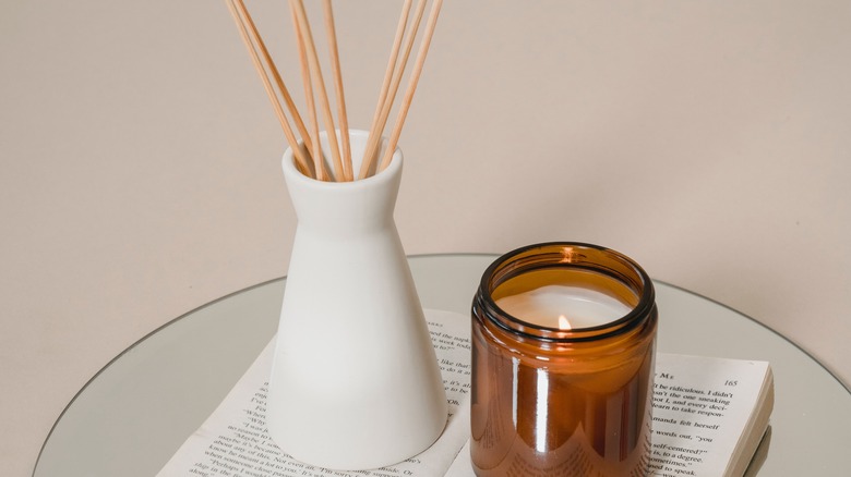 Amber glass candle on book pages