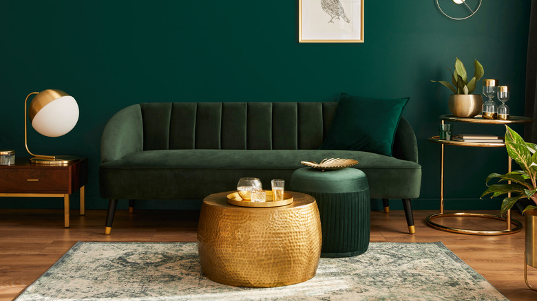 Emerald velvet couch with gold accents